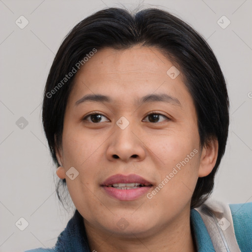 Joyful asian adult female with medium  brown hair and brown eyes