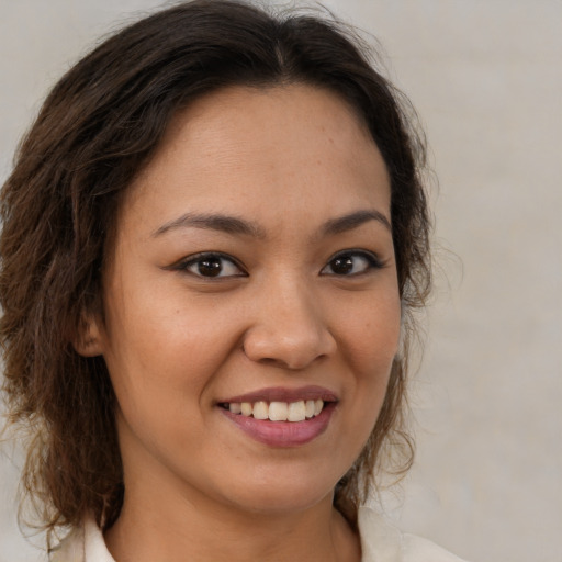 Joyful latino young-adult female with medium  brown hair and brown eyes