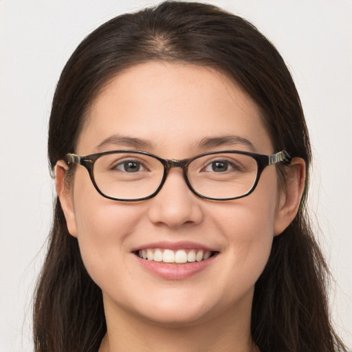 Joyful white young-adult female with long  brown hair and brown eyes