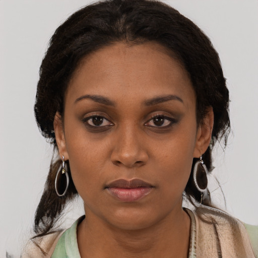 Neutral black young-adult female with medium  brown hair and brown eyes