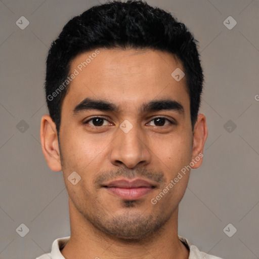 Joyful latino young-adult male with short  black hair and brown eyes