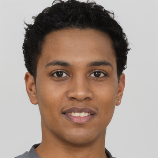 Joyful latino young-adult male with short  brown hair and brown eyes