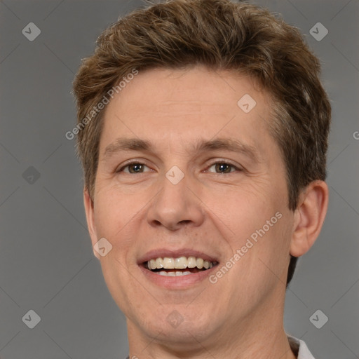 Joyful white adult male with short  brown hair and brown eyes