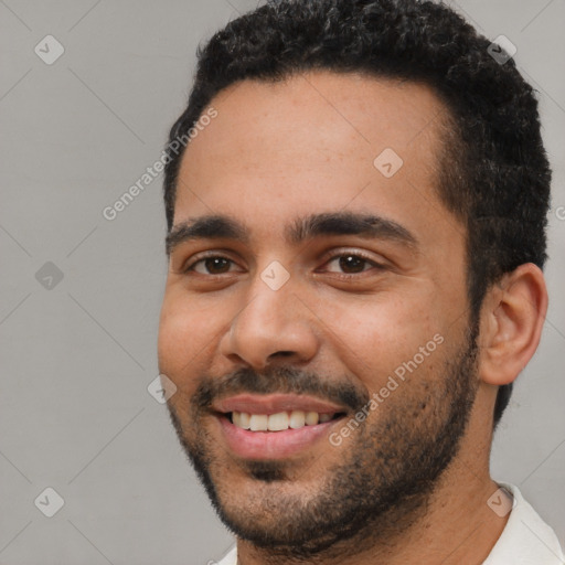 Joyful white young-adult male with short  black hair and brown eyes