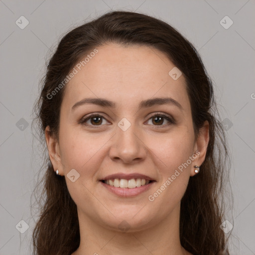 Joyful white young-adult female with long  brown hair and brown eyes