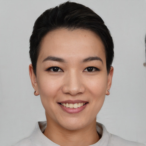 Joyful white young-adult female with short  black hair and brown eyes