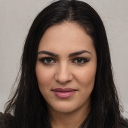 Joyful latino young-adult female with long  brown hair and brown eyes