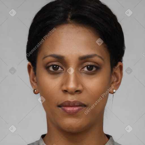 Joyful black young-adult female with short  black hair and brown eyes