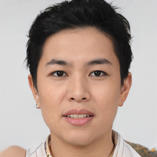 Joyful asian young-adult male with short  brown hair and brown eyes