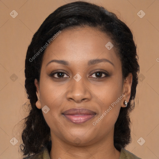 Joyful black young-adult female with long  brown hair and brown eyes