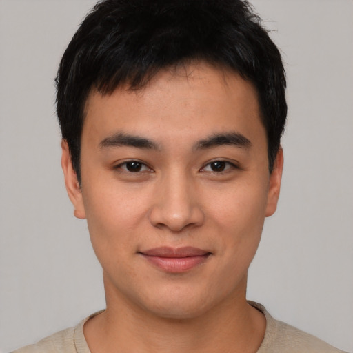 Joyful asian young-adult male with short  black hair and brown eyes