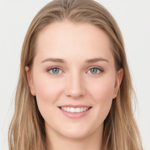 Joyful white young-adult female with long  brown hair and grey eyes