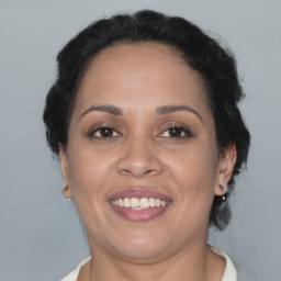 Joyful black adult female with medium  brown hair and brown eyes