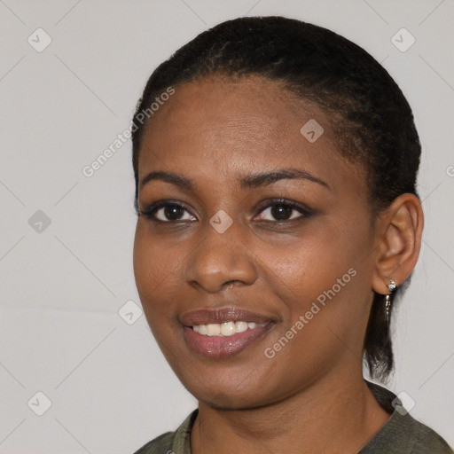 Joyful black young-adult female with short  black hair and brown eyes