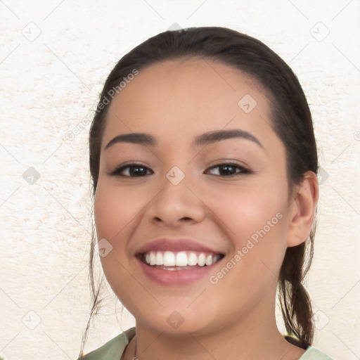 Joyful white young-adult female with long  black hair and brown eyes