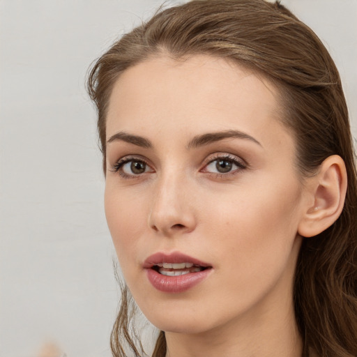 Neutral white young-adult female with long  brown hair and brown eyes