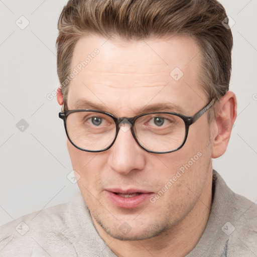 Joyful white adult male with short  brown hair and grey eyes