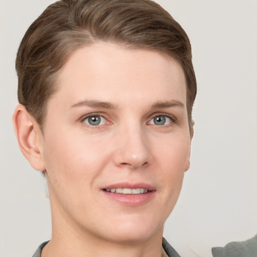 Joyful white young-adult female with short  brown hair and grey eyes