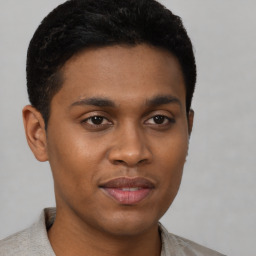 Joyful black young-adult male with short  brown hair and brown eyes