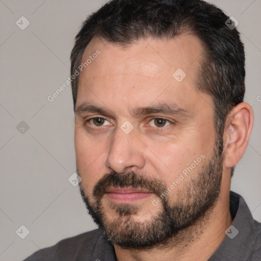 Joyful white adult male with short  black hair and brown eyes