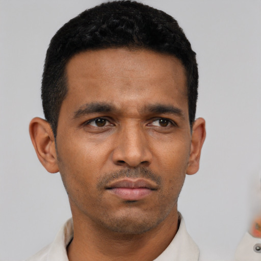 Neutral latino young-adult male with short  black hair and brown eyes