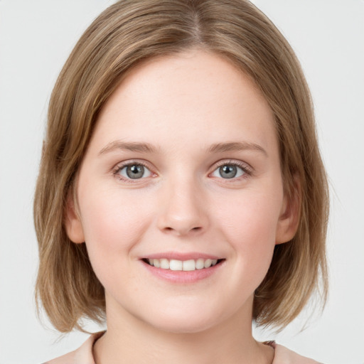 Joyful white young-adult female with medium  brown hair and blue eyes