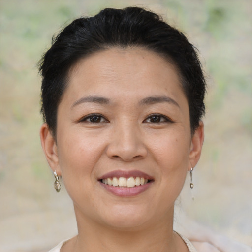 Joyful asian young-adult female with short  brown hair and brown eyes