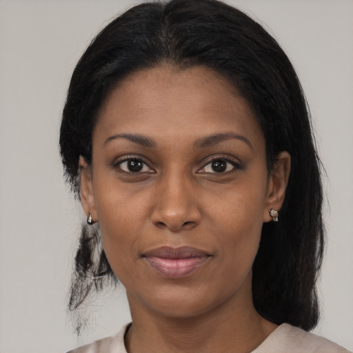 Joyful black young-adult female with medium  black hair and brown eyes