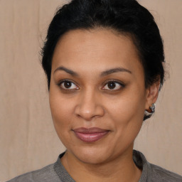 Joyful latino young-adult female with short  brown hair and brown eyes