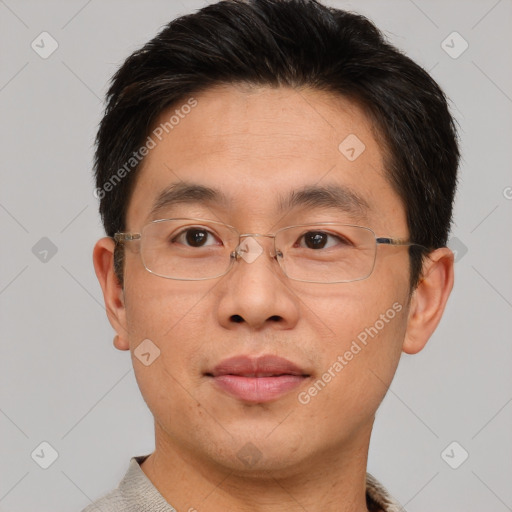 Joyful asian adult male with short  brown hair and brown eyes