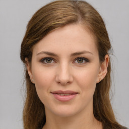 Joyful white young-adult female with long  brown hair and green eyes