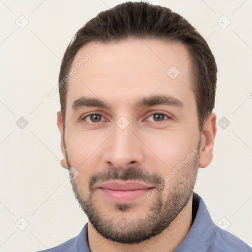 Joyful white young-adult male with short  brown hair and brown eyes