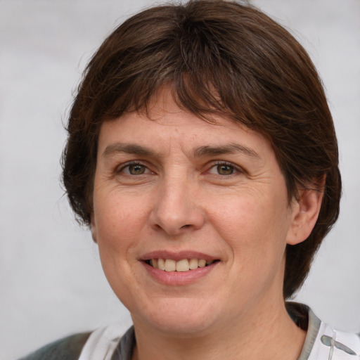 Joyful white adult female with medium  brown hair and grey eyes