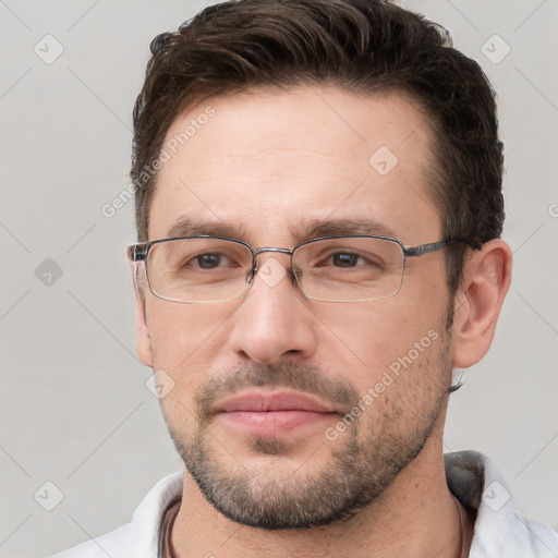 Joyful white adult male with short  brown hair and brown eyes