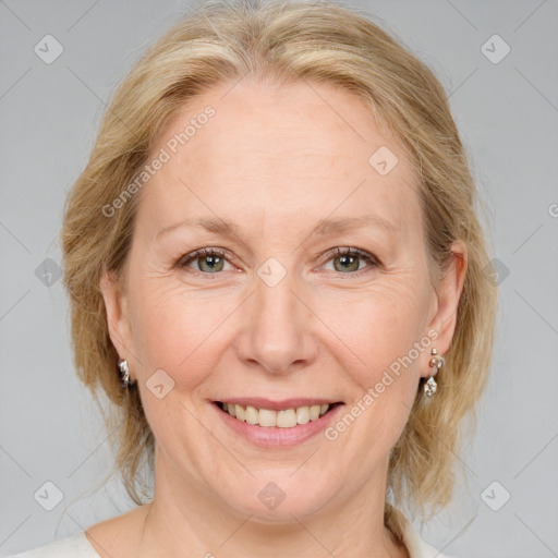 Joyful white adult female with medium  brown hair and blue eyes