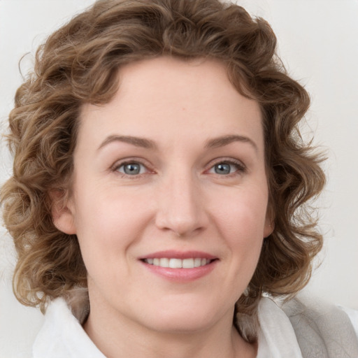 Joyful white young-adult female with medium  brown hair and blue eyes