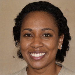 Joyful black adult female with medium  brown hair and brown eyes