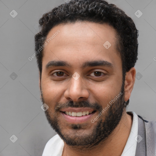 Joyful latino young-adult male with short  black hair and brown eyes