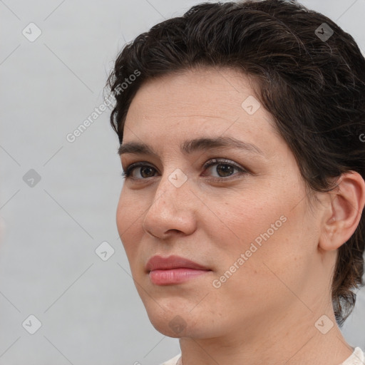 Joyful white adult female with medium  brown hair and brown eyes