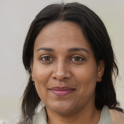 Joyful black adult female with medium  brown hair and brown eyes