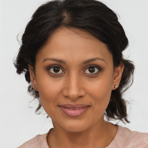 Joyful black young-adult female with medium  brown hair and brown eyes