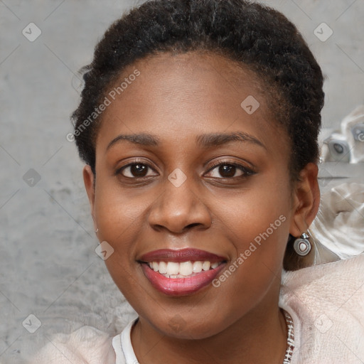 Joyful black young-adult female with short  brown hair and brown eyes