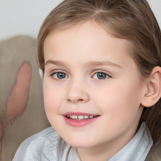 Joyful white child female with medium  brown hair and blue eyes