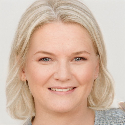 Joyful white young-adult female with medium  blond hair and blue eyes