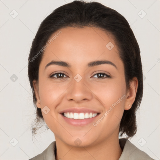 Joyful latino young-adult female with medium  brown hair and brown eyes