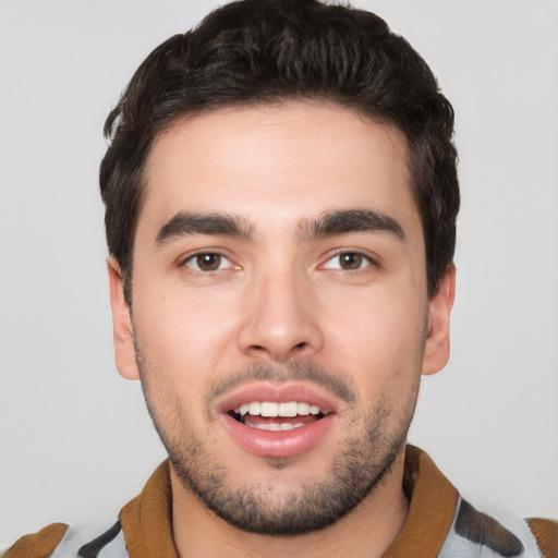 Joyful white young-adult male with short  black hair and brown eyes