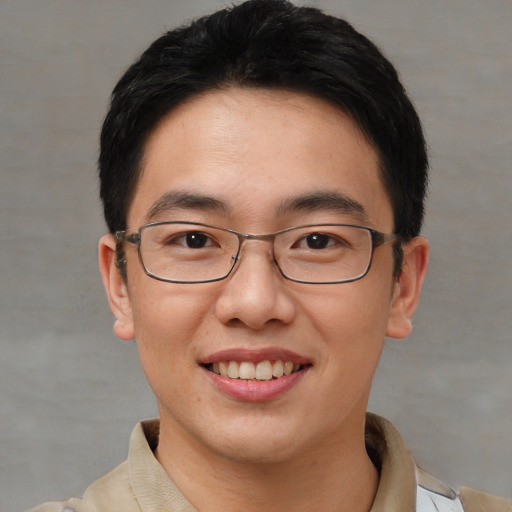 Joyful asian young-adult male with short  brown hair and brown eyes