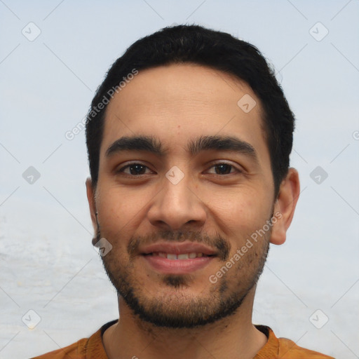 Joyful latino young-adult male with short  black hair and brown eyes