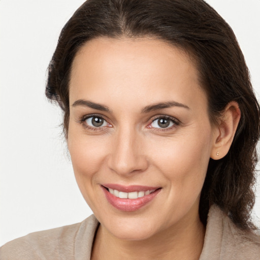 Joyful white young-adult female with medium  brown hair and brown eyes