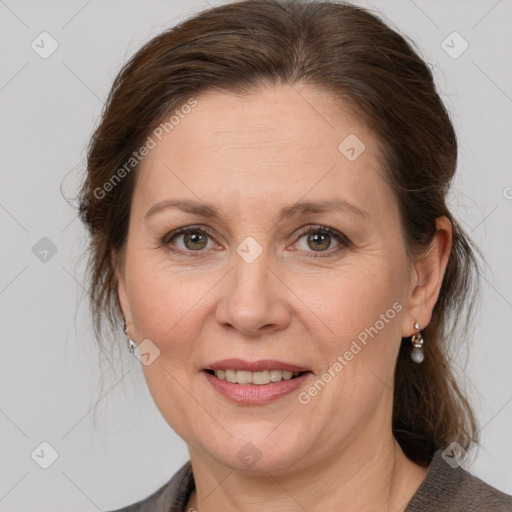 Joyful white adult female with medium  brown hair and grey eyes